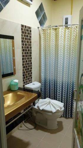 a bathroom with a toilet and a sink and a shower at ฺBankunyaiy Resort in Ko Yao Yai