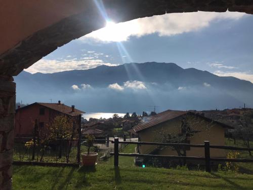 a view of a mountain from a house with the sun shining at Villa The Princess in Lenno
