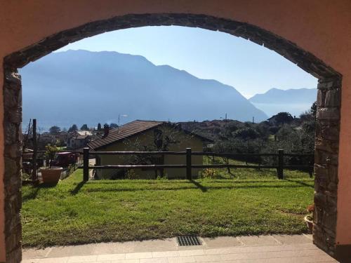 an archway in a yard with a view of mountains at Villa The Princess in Lenno