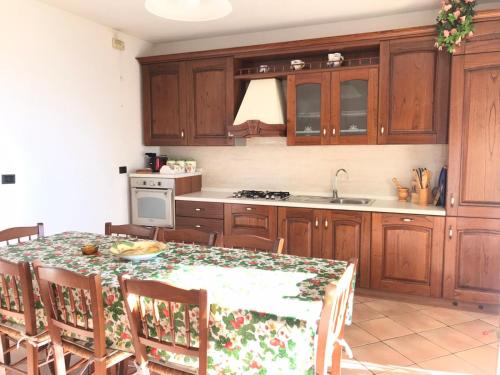 a kitchen with wooden cabinets and a table with chairs at Villa The Princess in Lenno