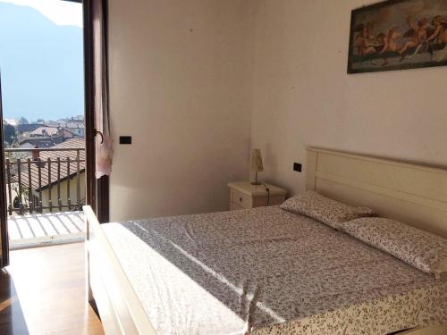 a bedroom with a bed and a large window at Villa The Princess in Lenno