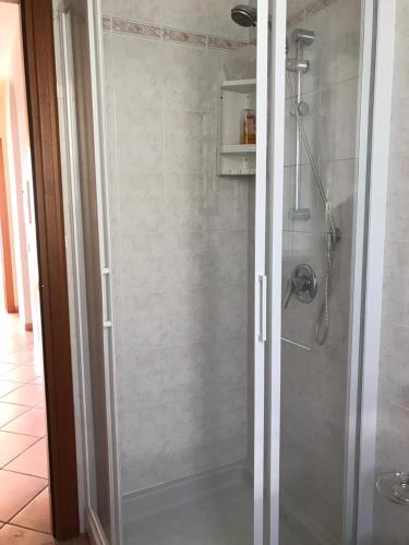 a shower with a glass door in a bathroom at Villa The Princess in Lenno