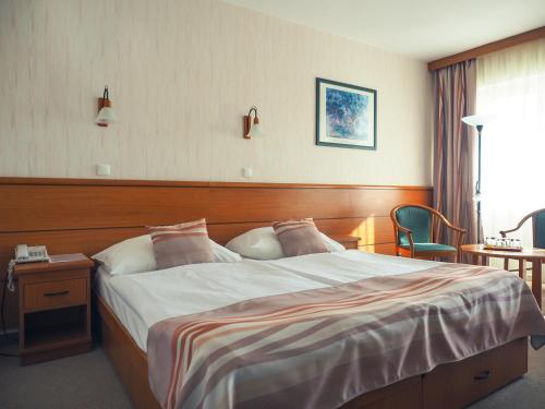 Postel nebo postele na pokoji v ubytování Hotel Panoráma