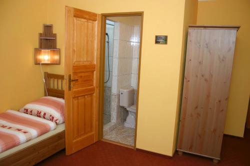a bathroom with a shower and a toilet and a door at Pension U Lípy in Rovečné