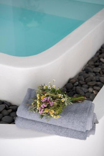 a bouquet of flowers sitting on a step at Zefi Hotel & Suites in Naousa