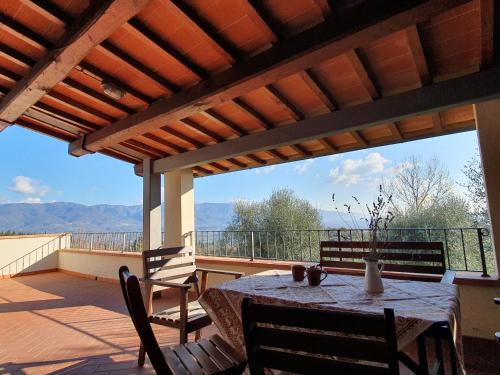 a patio with a table and chairs on a balcony at Castello di Pratelli in Incisa in Valdarno