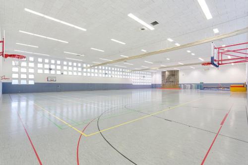 an empty gymnasium with a basketball hoop and a court at Sportpark Rabenberg in Breitenbrunn