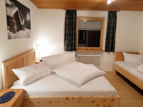 a bedroom with two beds and a window at Mooshof in Kaunertal