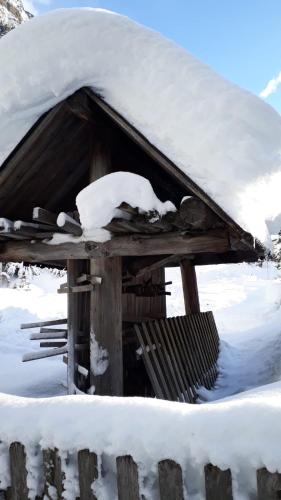 a snow covered cabin with a pile of snow on it at Mooshof in Kaunertal