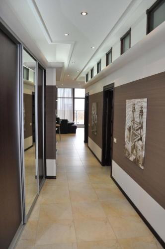 a hallway of an office building with paintings on the walls at Arcadia Palace Apartments with Sea View in Odesa