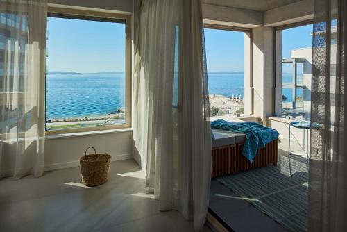 a room with a window with a view of the ocean at Eol Apartments Split in Split