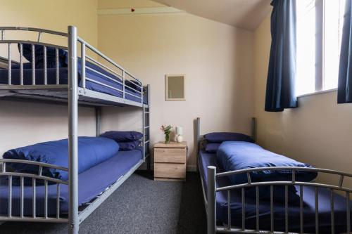 a room with two bunk beds and a window at Durness Youth Hostel in Durness