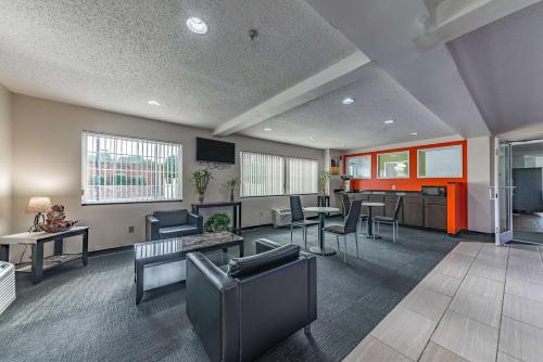 a waiting room with chairs and tables in a building at Motel 6-Charlotte, NC - University in Charlotte