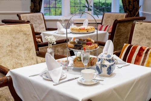 a table with a plate of food on it at Castle Bromwich Hall; Sure Hotel Collection by Best Western in Birmingham