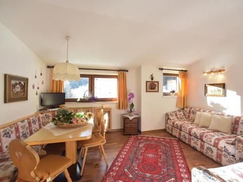 a living room with a table and a couch at Residence Salvan in Corvara in Badia