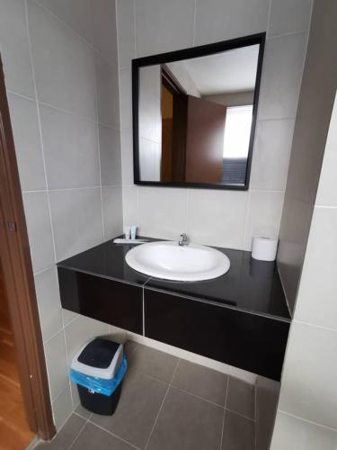 a bathroom with a sink and a mirror at Tatami D'Tepi Laut - PANGKOR ISLAND in Pangkor