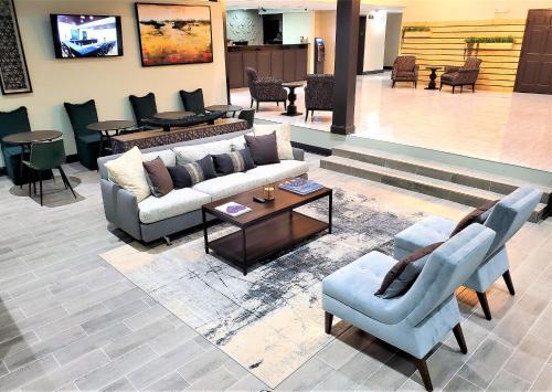 a lobby with a couch and chairs and a table at Super 8 by Wyndham High Point/Greensboro in High Point
