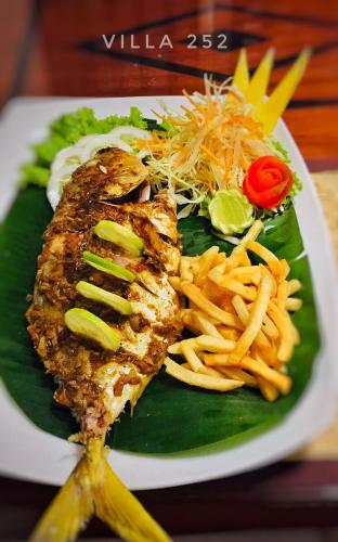 a plate of food with fish and french fries at Villa 252 Kosgoda in Kosgoda