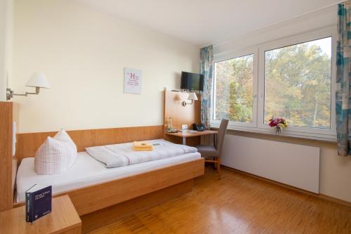Postel nebo postele na pokoji v ubytování Das Gästehaus Puschendorf
