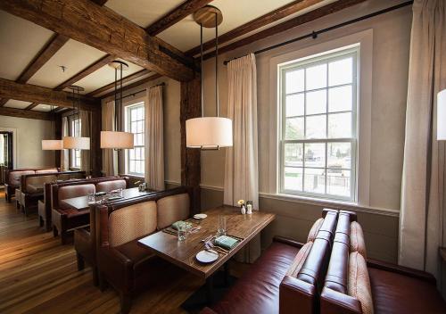 a dining room with a table and leather chairs at Boar's Head Resort in Charlottesville