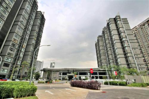 two tall buildings in a city with a parking lot at The ComfyHauz # Cyberjaya in Cyberjaya