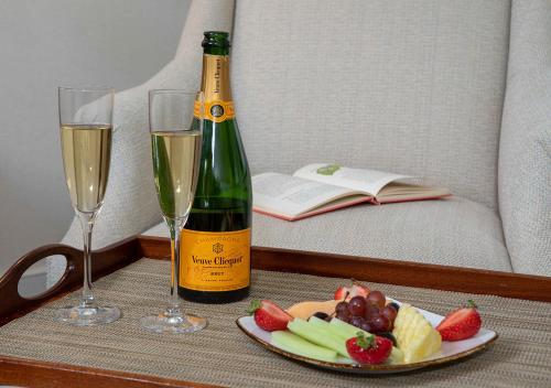 a table with a bottle of champagne and a plate of fruit at Boar's Head Resort in Charlottesville
