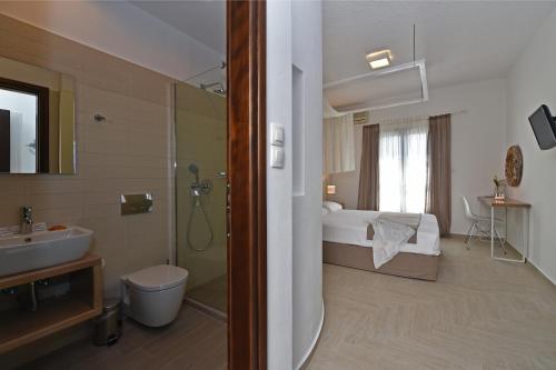 a bathroom with a sink and a toilet and a shower at Aella Residence in Naousa