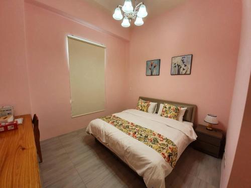 a bedroom with a bed and a mirror on the wall at Clare Holiday B&B in Checheng