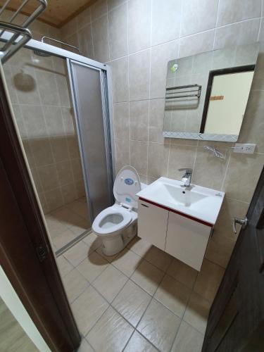 a bathroom with a toilet and a shower and a sink at Clare Holiday B&B in Checheng