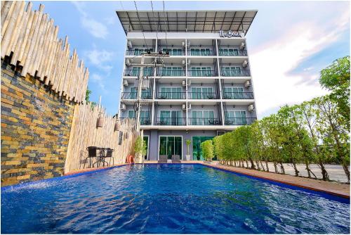a swimming pool in front of a building at The Beach at Klong Muang in Klong Muang Beach