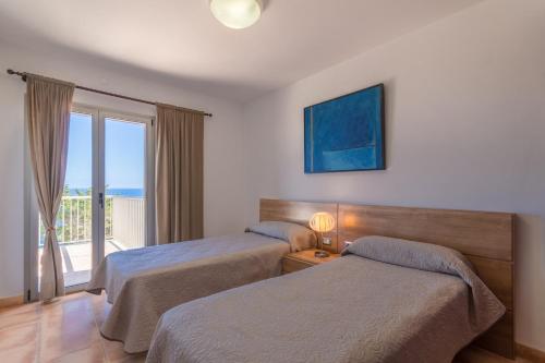a hotel room with two beds and a balcony at Cala Murada - 2778-83 Mallorca in Cala Murada