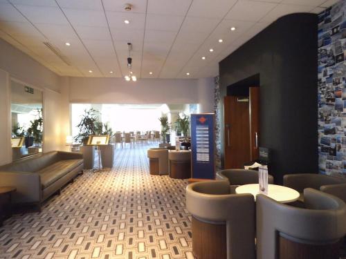 a large room with a lot of tables and chairs at Airport Inn Gatwick in Horley