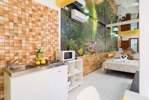 a kitchen with a sink and a couch in a room at Rooms Young People Only, Soho CityCenter in Málaga