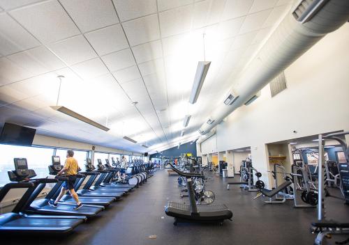 a large gym with people exercising on tread machines at Boar's Head Resort in Charlottesville