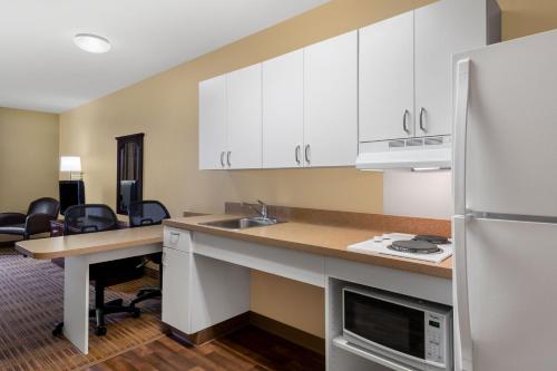 a kitchen with a sink and a refrigerator at Extended Stay America Suites - Chicago - Woodfield Mall in Schaumburg