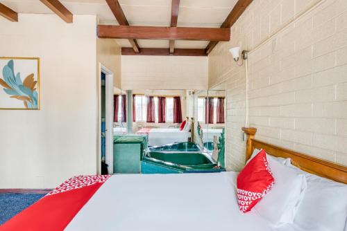 a bedroom with a bed and a boat in a room at OYO Oasis Motel Las Vegas I-15 in Las Vegas
