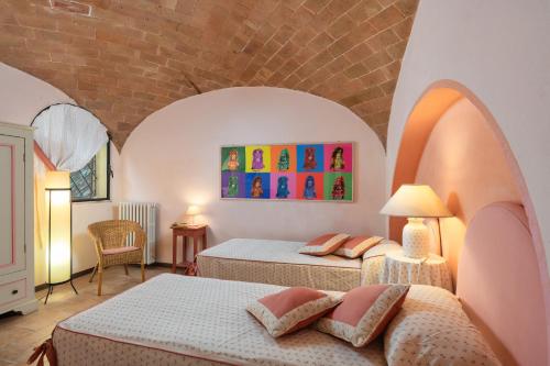 a bedroom with two beds in a room at Podere Oliveta in Poggibonsi
