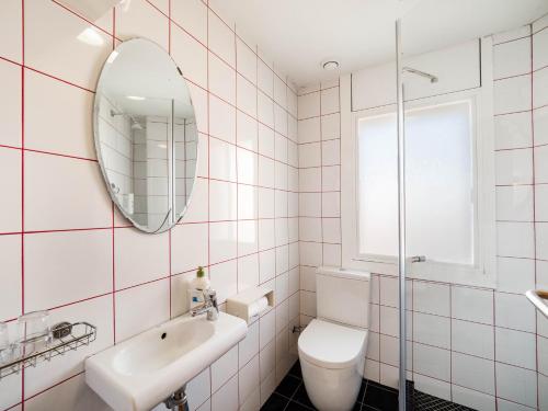 a bathroom with a sink toilet and a mirror at Hostal Athenas in Sant Adria de Besos