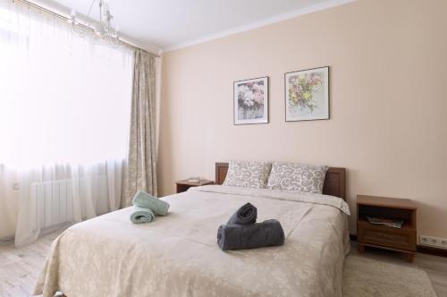 a bedroom with a bed with two towels on it at 1BR apartment in the old city center (Kyïv) in Kyiv