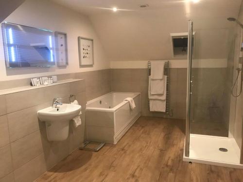 a bathroom with a sink toilet and a shower at Hotel La Place in Saint Aubin