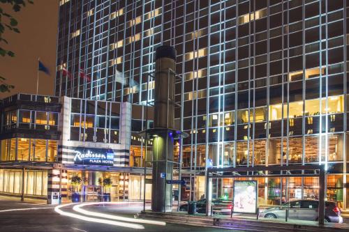 a tall building with a car parked in front of it at Radisson Blu Plaza Hotel, Oslo in Oslo