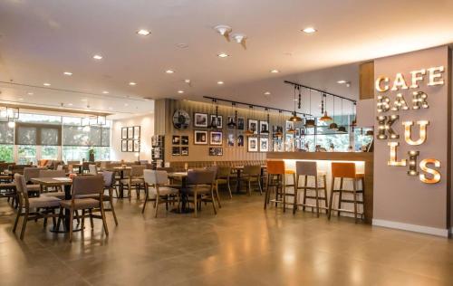 a restaurant with tables and chairs and a bar at Radisson Blu Ankara in Ankara