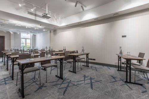 a large room with tables and chairs in it at Radisson Blu Hotel Prague in Prague