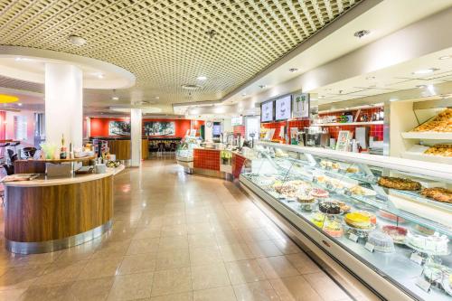 a grocery store aisle with a lot of food at Radisson Blu Hotel Olümpia in Tallinn