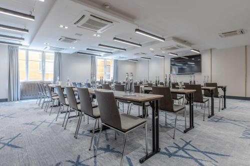 a large room with tables and chairs in it at Radisson Blu Hotel Prague in Prague