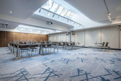 a large room with tables and chairs in it at Radisson Blu Hotel Prague in Prague