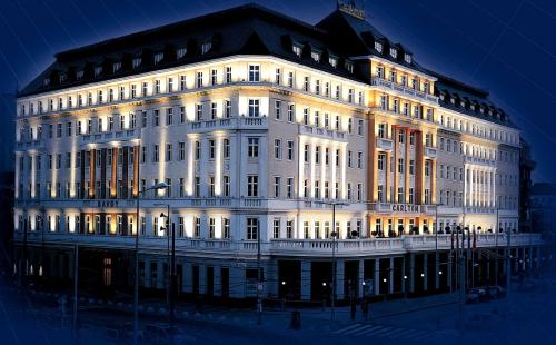 a large white building with its lights on at Radisson Blu Carlton Hotel, Bratislava in Bratislava