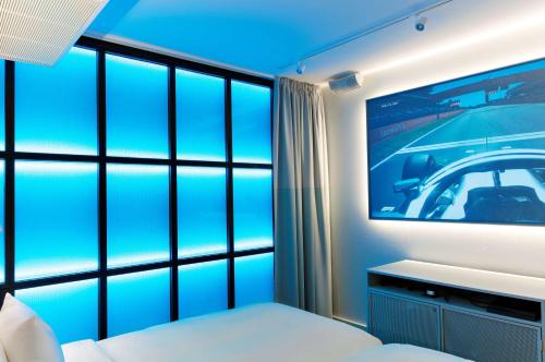 a bedroom with a large tv and a bed at Radisson Blu Seaside Hotel, Helsinki in Helsinki