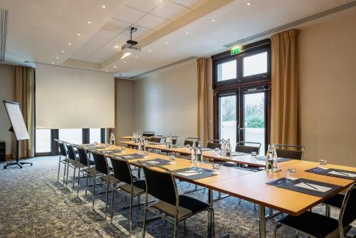 a conference room with a long table and chairs at Radisson Blu Hotel Paris, Marne-la-Vallée in Magny-le-Hongre
