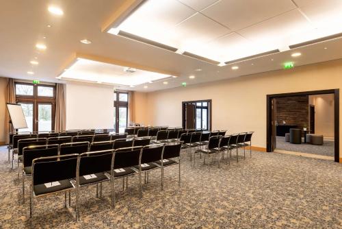 an empty room with chairs and a stage at Radisson Blu Hotel Paris, Marne-la-Vallée in Magny-le-Hongre